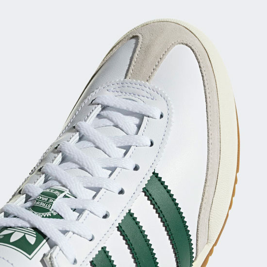 white adidas trainers with green stripes